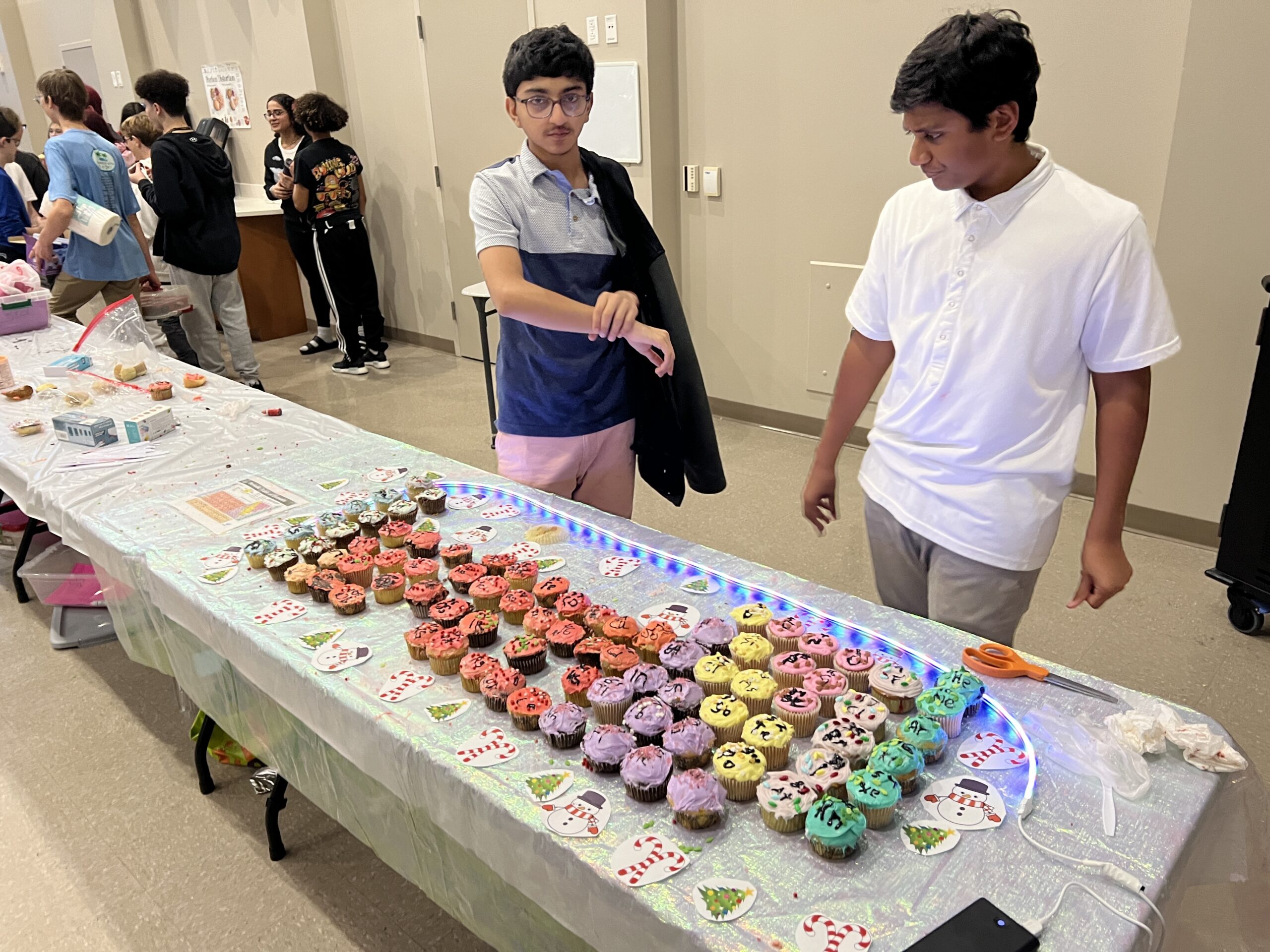 students next to their cupcake periodic table 