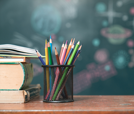 Image of four books and a bunch of colored pencils